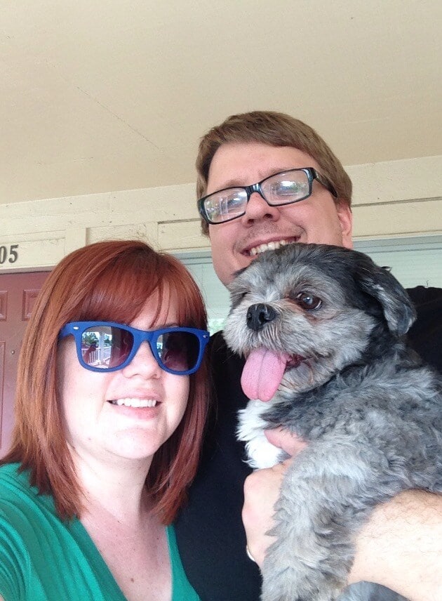 Man and woman pose for picture holding their shih tzu