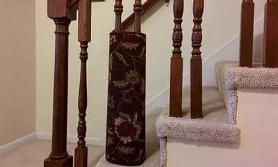 Flowered area rug wrapped around staircase spindle